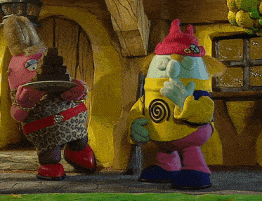 two stuffed animals are standing next to each other with one holding a plate of chocolates