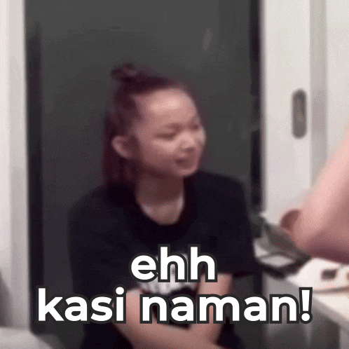a woman in a black shirt is sitting in front of a door with the words ehh kasi naman !