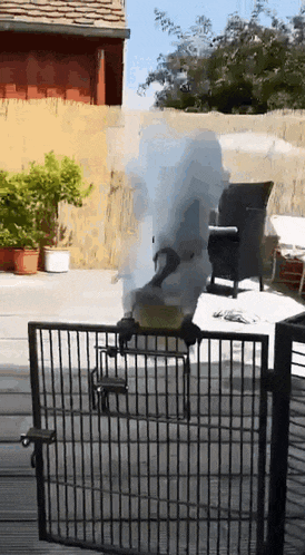 smoke is coming out of a fire pit on a patio
