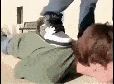 a person is kicking another person 's foot on the ground .