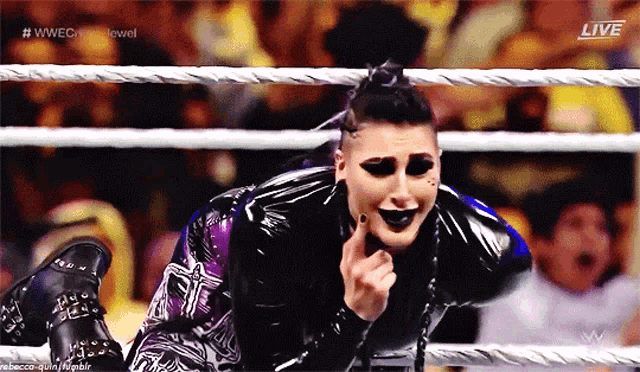a woman in a wrestling ring with the word live on the bottom right