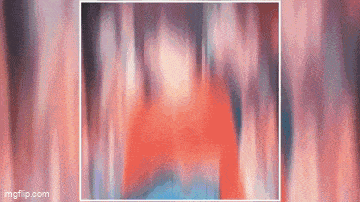 a blurry picture of a person standing in front of a curtain .