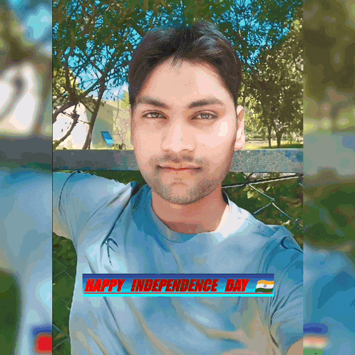 a man in a blue shirt is standing in front of a fence with the words happy independence day on the bottom