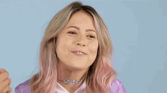 a woman with pink hair and a choker on her neck