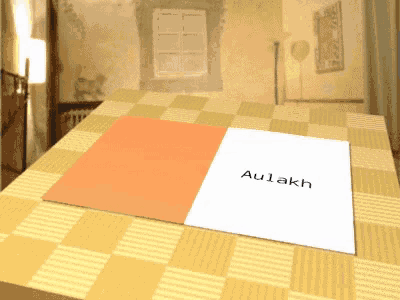a piece of paper on a table that says aulakh on it