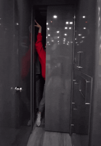a woman in a santa hat is standing in a doorway with the words ho ho ho on the bottom