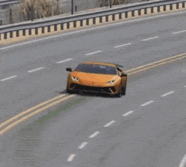 an orange lamborghini huracan is driving down a desert road .