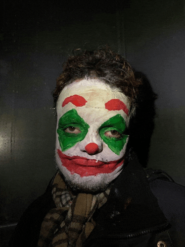 a man has his face painted like the joker