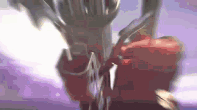 a blurry picture of a person holding a sword in their hand