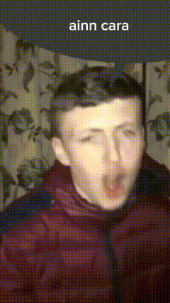 a man in a red jacket is making a funny face with the caption ainn cara