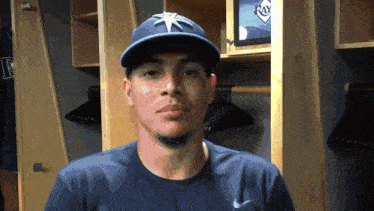 a man wearing a rays hat and a nike shirt