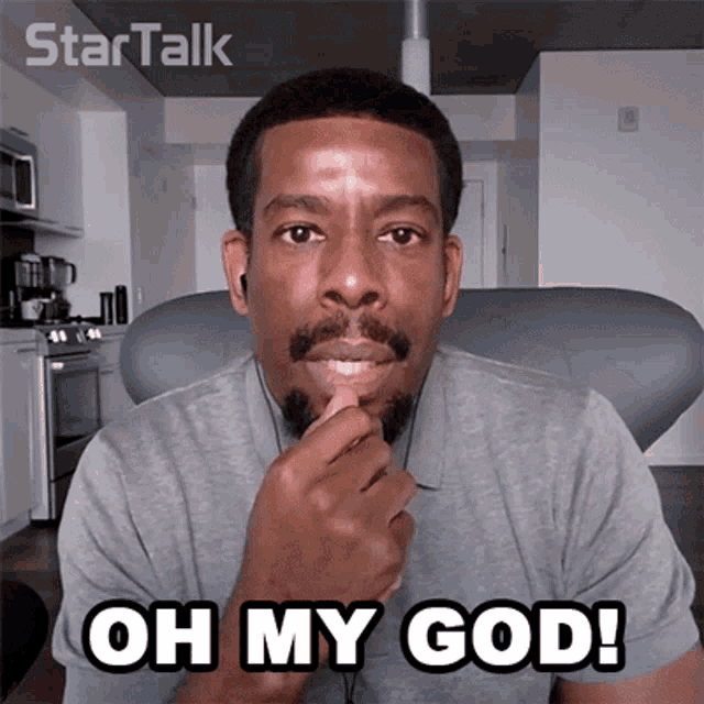 a man with a beard and ear buds says " oh my god "