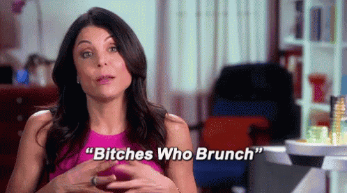 a woman in a pink dress is talking to a camera and says `` bitches who brunch '' .