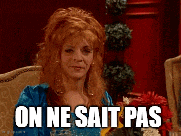 a woman with red hair is sitting in a chair with a glass of wine and the words `` on ne sait pas '' .