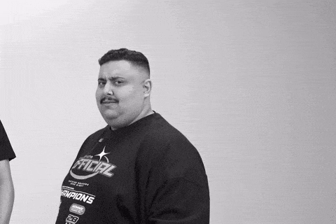a black and white photo of a man wearing a shirt that says facial champions .