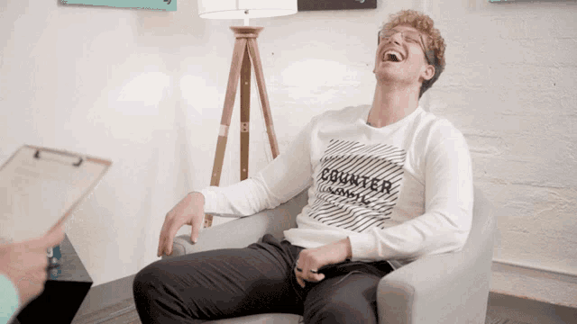 a man wearing a white shirt that says counter laughs