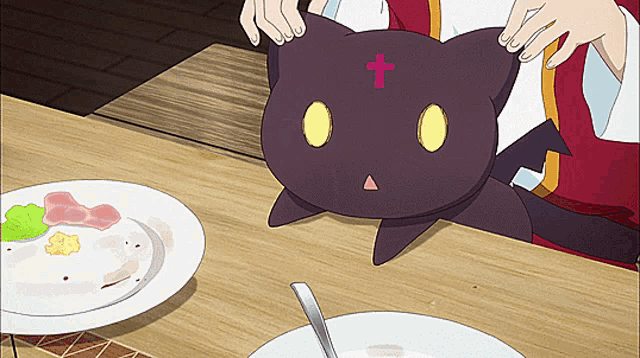 a black cat with a cross on its head sits on a table next to a bowl of soup