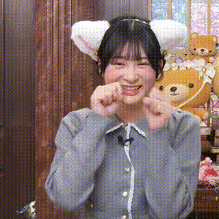 a girl wearing a cat ear headband is making a funny face .