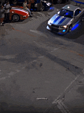 a car is driving down a street in front of a miami sign