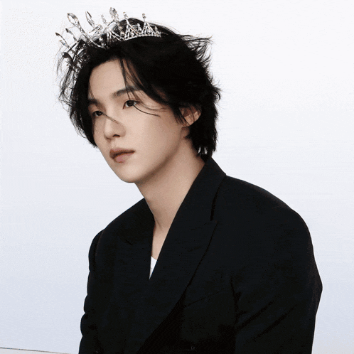 a man wearing a tiara and a black jacket