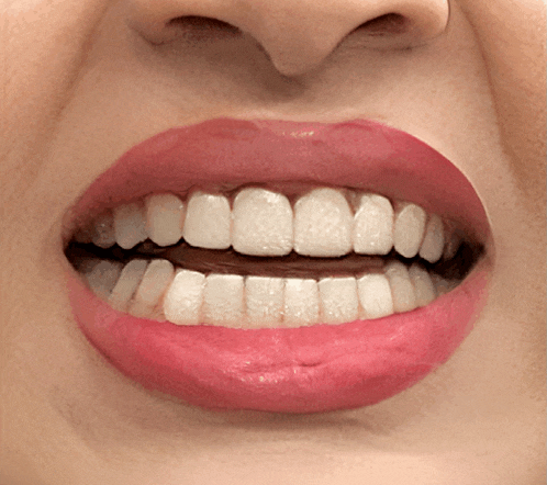 a close up of a woman 's mouth with white teeth and red lipstick