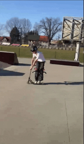 a person riding a scooter on a skate park