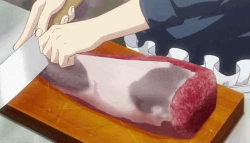 a person is cutting a large piece of meat on a wooden cutting board