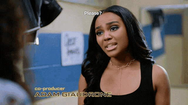 a woman in a black tank top with the name adam giaudrone on the bottom right