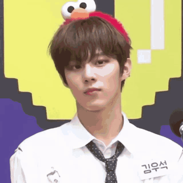 a young man wearing a headband with elmo on it .
