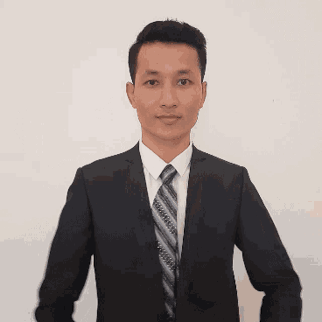 a man in a suit and tie is giving a handshake