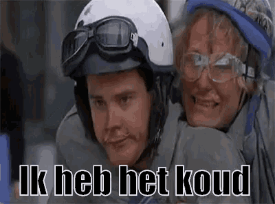 a man wearing a helmet and goggles is carrying a woman .