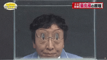 a man wearing glasses is making a funny face while sitting in a tank of water .