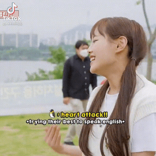 a girl with pigtails is talking about trying their best to speak english while wearing a mask .