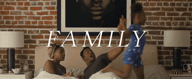 a man and woman are laying on a bed with a child and the word family written on the bottom