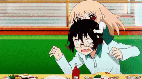 a cartoon girl is sitting at a table with a bottle of ketchup .