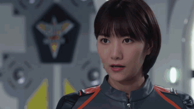 a woman in a military uniform looks at the camera with a pentagon in the background