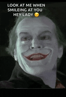 a close up of a man with a joker face on his face