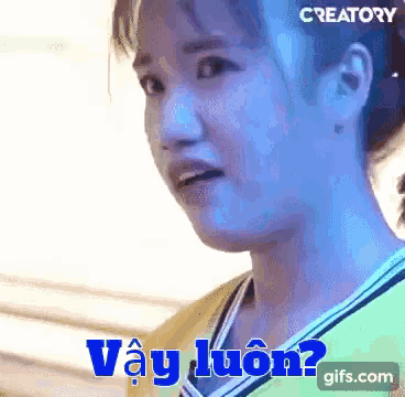 a close up of a woman 's face with the words vay luôn written in blue