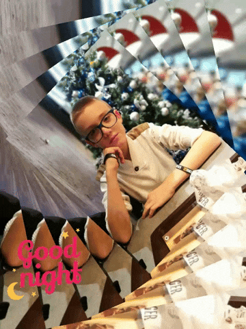 a picture of a boy sitting at a table with the words good night in red