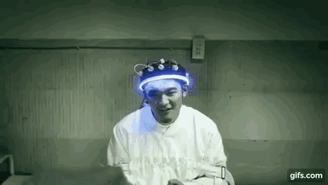 a man in a straitjacket with a blue light on his head .