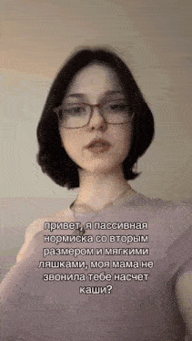 a woman wearing glasses and a purple shirt is talking in a foreign language