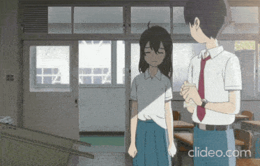 a boy and a girl are standing in a classroom with the website clideo.com visible
