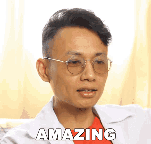 a man wearing glasses and a white lab coat says " amazing "