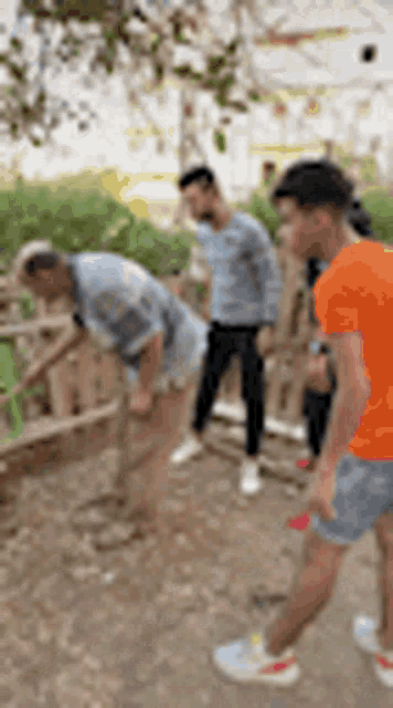 a group of men are standing next to each other on a sidewalk .