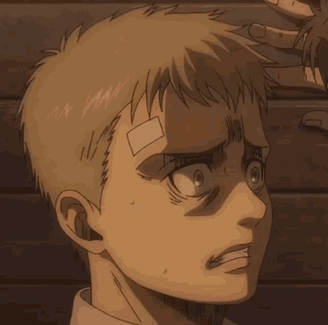 a young boy with a bandage on his forehead