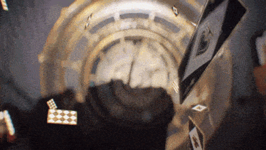 playing cards are falling in front of a clock that has the hands on the numbers 1 and 2