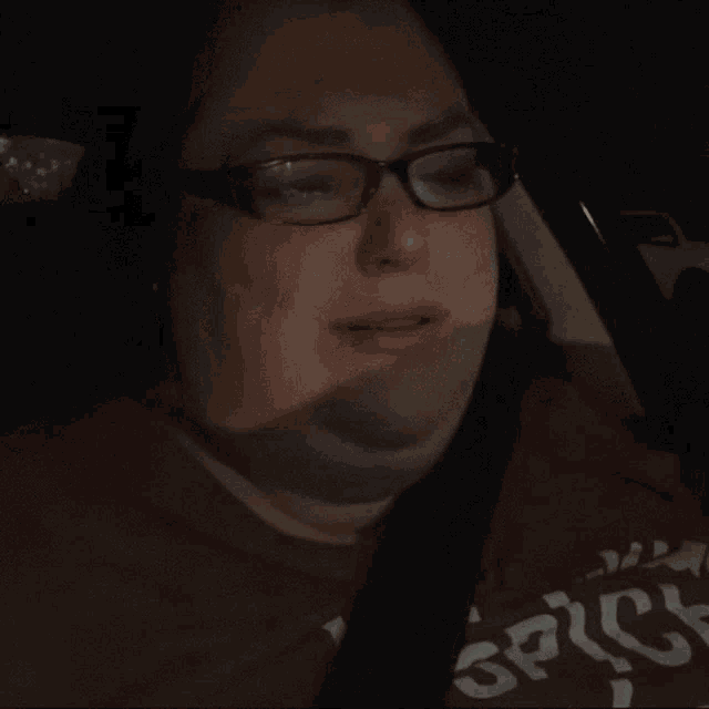 a woman wearing glasses and a red shirt that says spice on it
