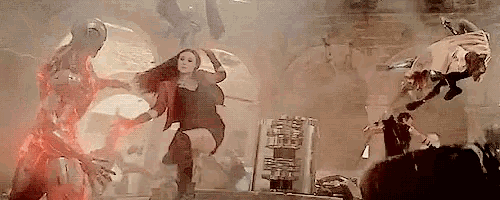 a woman in a red dress is dancing in front of a group of people .