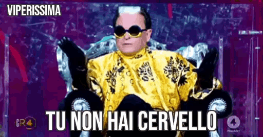 a man wearing sunglasses and a gold shirt is sitting on a throne with the words " tu non hai cervello " on the bottom