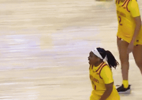 a basketball player wearing a yellow jersey that says cleveland